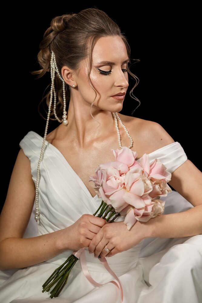 Bridal makeup with a soft eye and pink bouquet