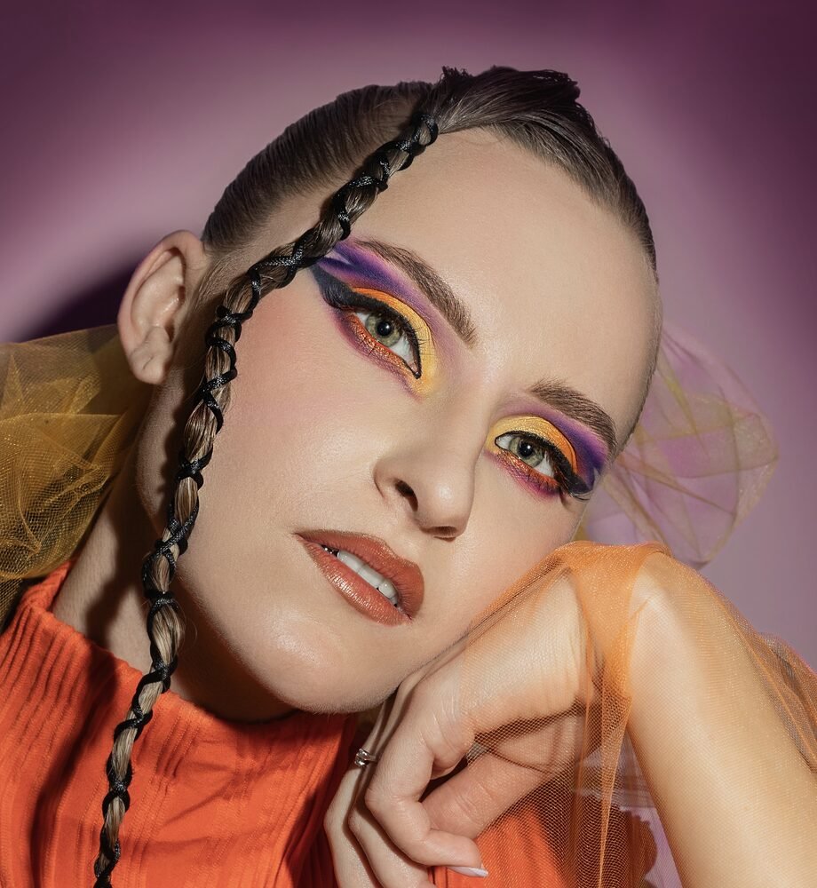 Colourful graphic eye makeup styled with braids