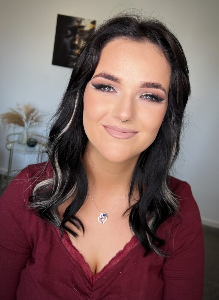Evening glam makeup with a warm smoky eye on a client