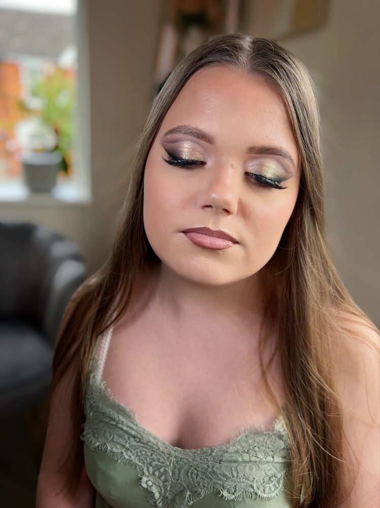 Client with eyes closed showing a soft green and gold eye look