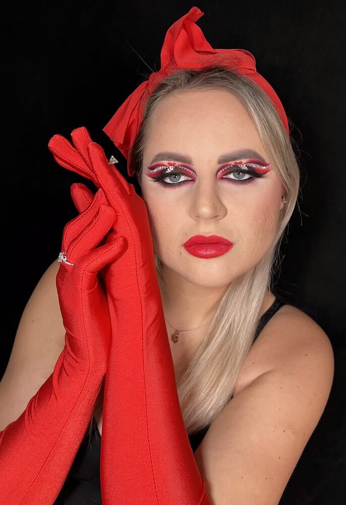Red glitter eye makeup styled with red gloves and headwrap