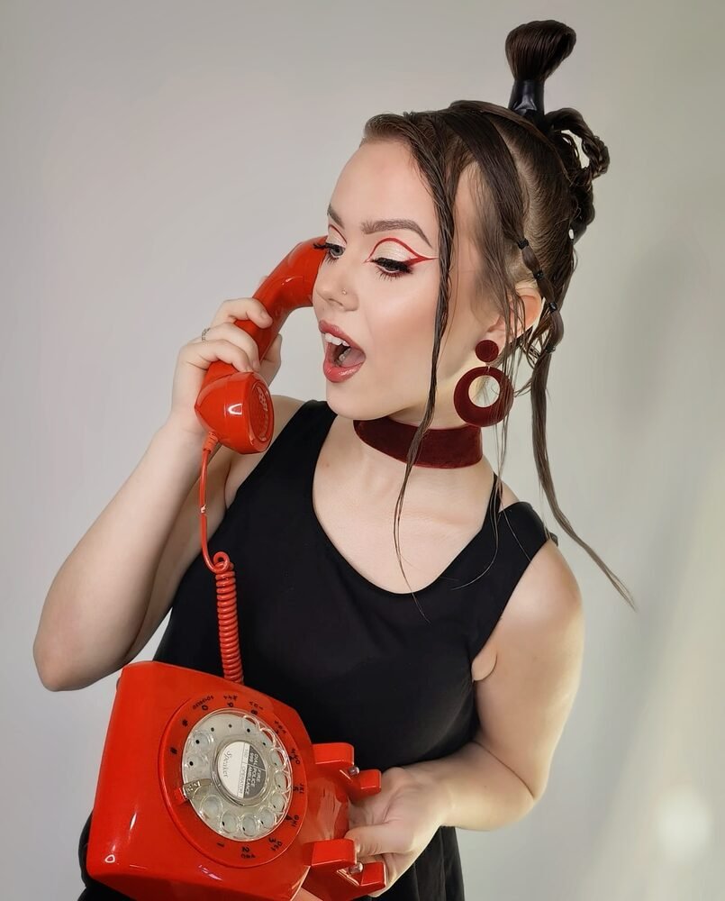 Retro pin up makeup styled with a red telephone