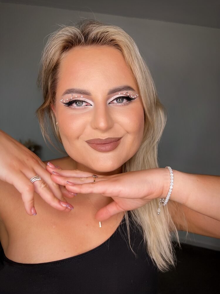 Soft glam makeup with a graphic liner detail on a client