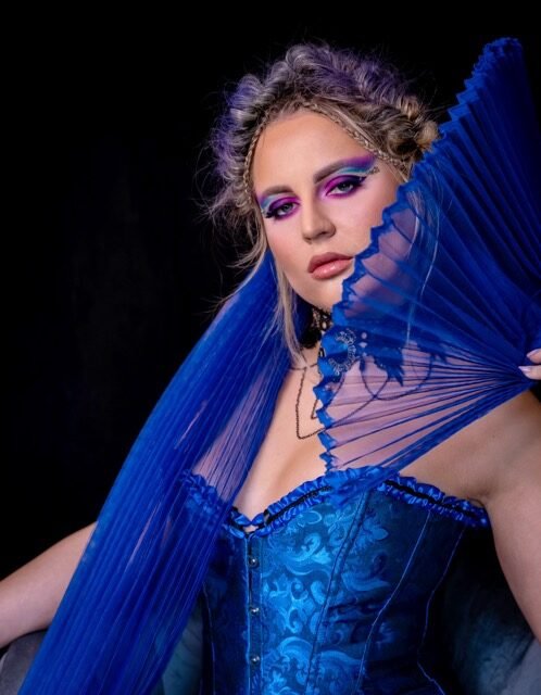 Purple and blue eye look styled with a blue corset