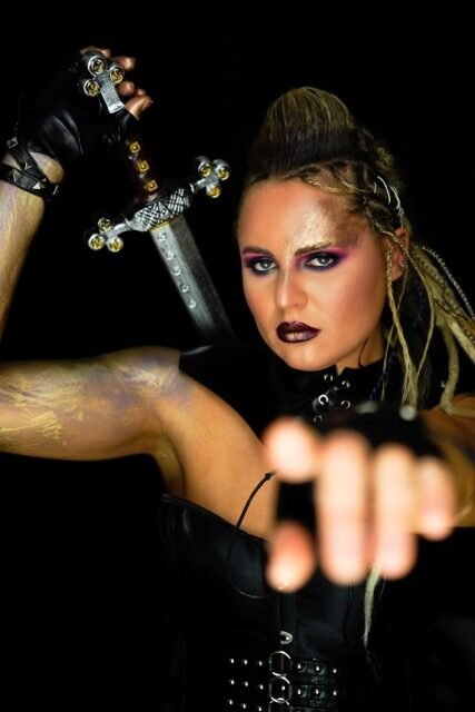 Dark editorial makeup with strong contouring and a bold lip