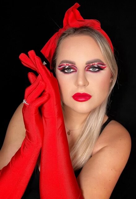 Red glitter eye look styled with red gloves and a red headwrap